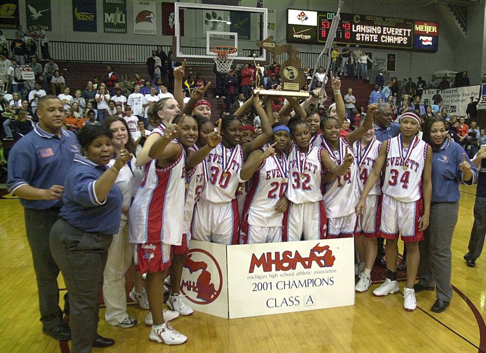 The Lansing Everett girls basketball team celebrates its state championship victory in 2001 in Mt. Pleasant.