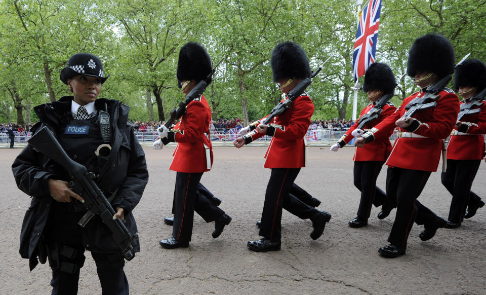 Soldiers move along The Mall to take their positions as part of Queen Elizabeth II Diamond Jubilee celebrations, London, Tuesday June 5, 2012. Queen Elizabeth II will make a rare address to the nation at the conclusion of festivities marking her 60 years on the throne. (AP Photo/Tom Hevezi)