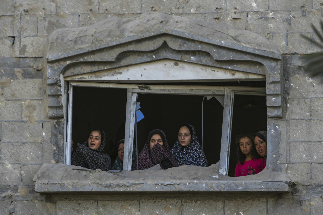 Palestinians look at the destruction after an Israeli airstrike on a crowded tent camp housing Palestinians displaced by the war in Muwasi, Gaza Strip, Tuesday, Sept. 10, 2024. An Israeli strike killed at least 40 people and wounded 60 others early Tuesday, Palestinian officials said. Israel said it targeted "significant" Hamas militants, allegations denied by the militant group. (AP Photo/Abdel Kareem Hana)