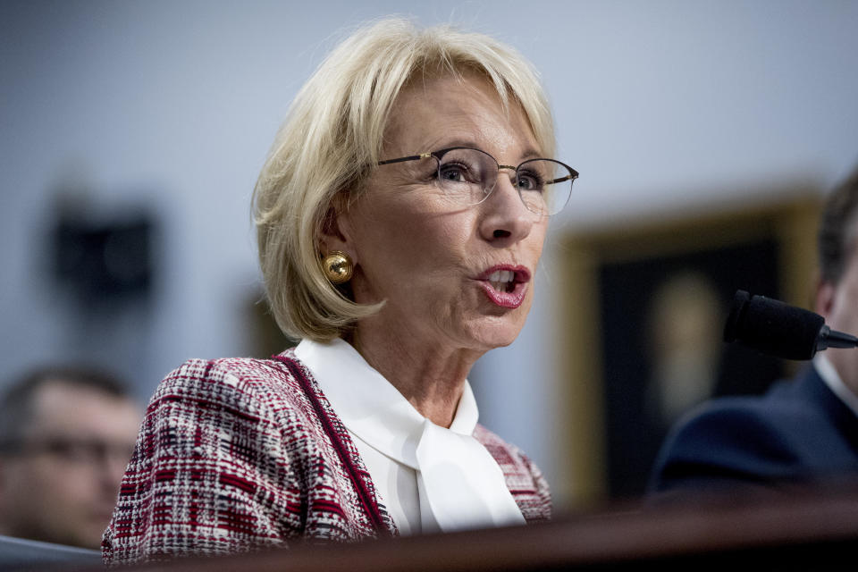 FILE - In this March 26, 2019 file photo, Education Secretary Betsy DeVos speaks during a House Appropriations subcommittee hearing on Capitol Hill in Washington.   The Education Department is fining Michigan State University $4.5 million for failing to respond to sexual assault complaints against Dr. Larry Nassar.  The announcement was made Thursday by Education Secretary Betsy DeVos. (AP Photo/Andrew Harnik)