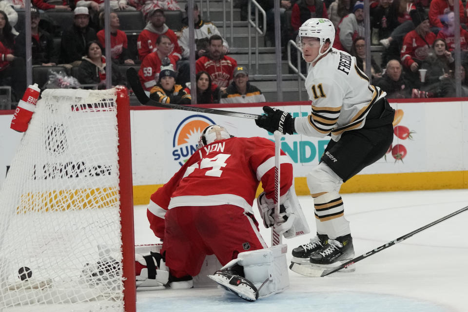 Boston Bruins center Trent Frederic (11) shoots the puck past Detroit Red Wings goalie Alex Lyon for a goal during the first period of an NHL hockey game, Sunday, Dec. 31, 2023, in Detroit. (AP Photo/Carlos Osorio)