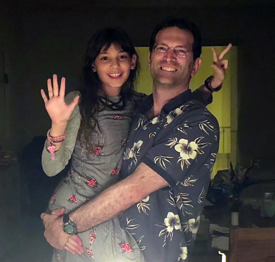 In this circa 2016/2017 photo provided by Soriya Cohen, Dr. Brad Cohen poses with his daughter Elisheva in their Miami home. Brad Cohen is one of the people identified on Friday, July 16, 2021, as having died in the collapse of the Champlain Towers South condominium complex, in Surfside, Fla. The shirt worn in the picture by Brad Cohen is his wife, Soriya's favorite. His mother bought it for him early in Brad and Soriya's marriage. "If I could have only one piece of clothing from him, it would be that shirt," said Soriya. (Soriya Cohen via AP)