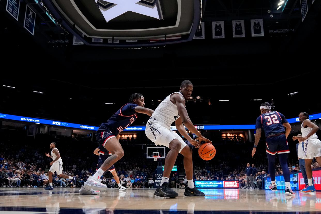 Robert Morris Colonials forward Stephaun Walker (11) defends Xavier Musketeers forward Abou Ousmane (24) in the first half of the NCAA Men’s basketball game between the Xavier Musketeers and the Robert Morris Colonials at the Cintas Center in Cincinnati on Monday, Nov. 6, 2023.
