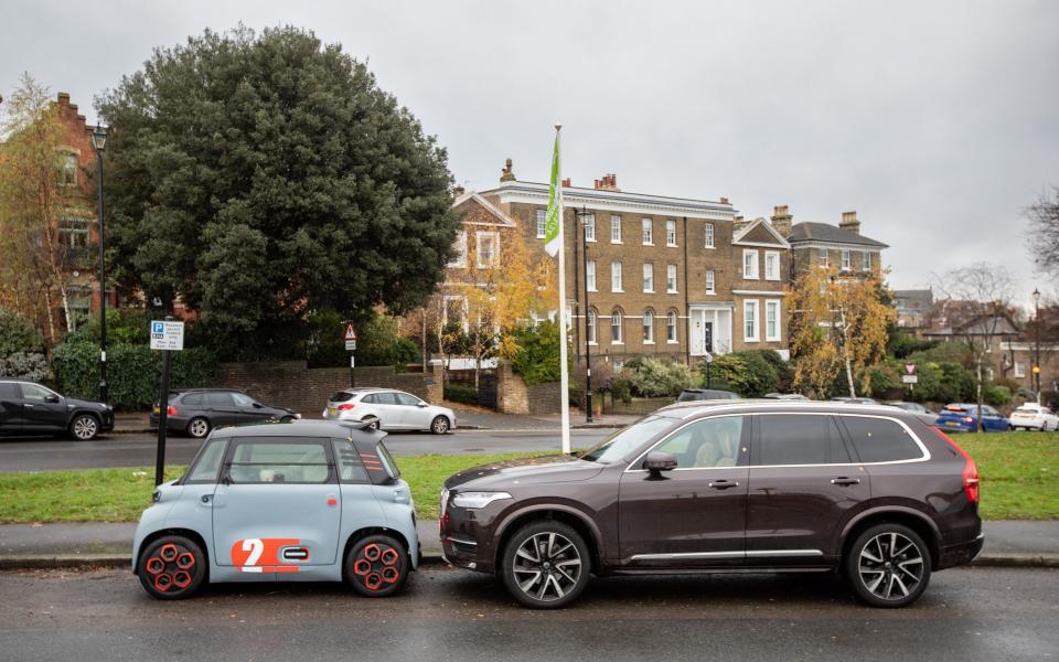 A Volvo next to a microcar, the Citroen Ami