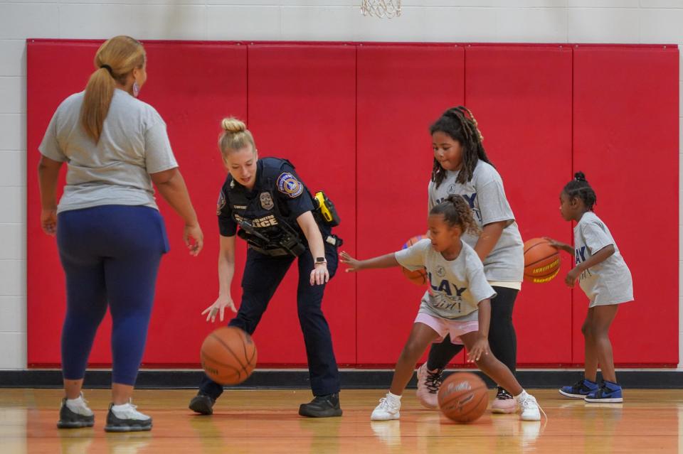 Indianapolis Metropolitan Police Department officer Tarah Butcher helps teach girls how to play defense during the Indianapolis Metropolitan Police Department's 'Play like a Girl' basketball clinic, on Saturday, July 27, 2024, in Indianapolis.