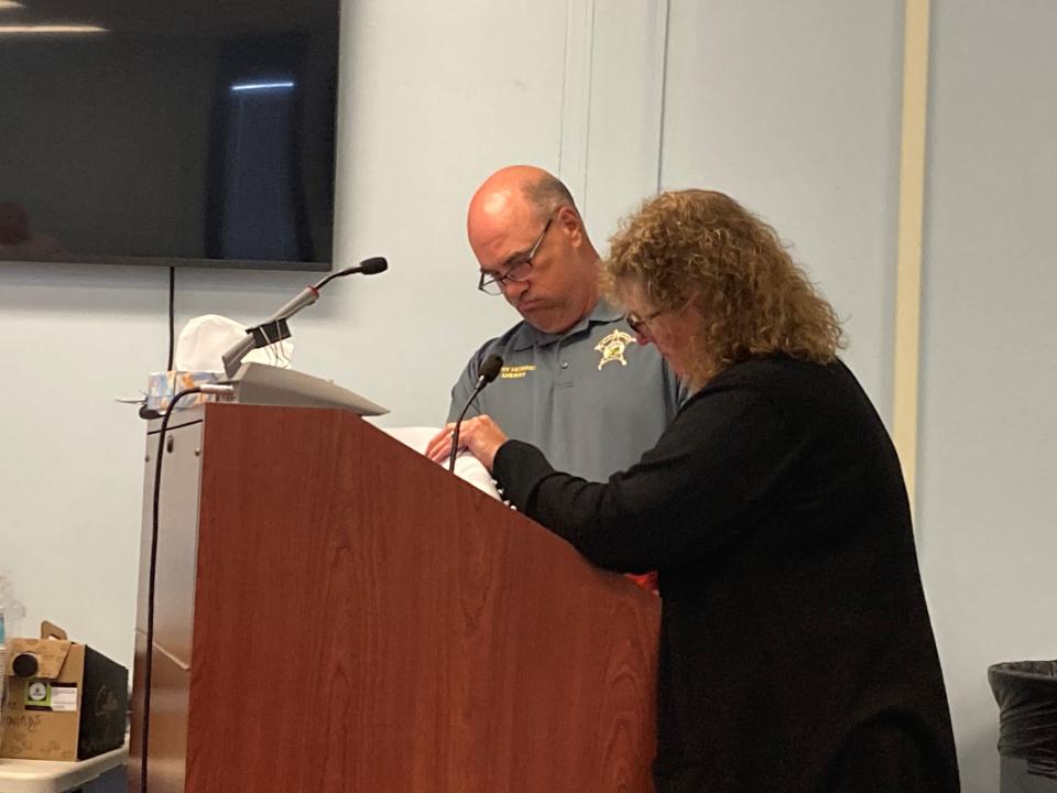 Sheriff Tony Skinner and Nancy Marvin, office manager for the Sheriff's Department, go over figures during the budget hearing for the Delaware County Jail Thursday. County office holders were required to go back into submitted budgets and find cuts  that can be made because of a projected revenue shortfall for county government.