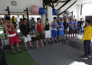 Secretary General of Afghanistan's boxing federation Waheedullah Hameedi, right, gives instructions to members of the Afghan national boxing team during a training session in local gym in Serbia, Wednesday, Dec. 1, 2021. They practiced in secrecy and sneaked out of Afghanistan to be able to compete at an international championship. Now, the Afghan boxing team are seeking refuge in the West to be able to continue both their careers and lives without danger or fear. (AP Photo/Darko Vojinovic)