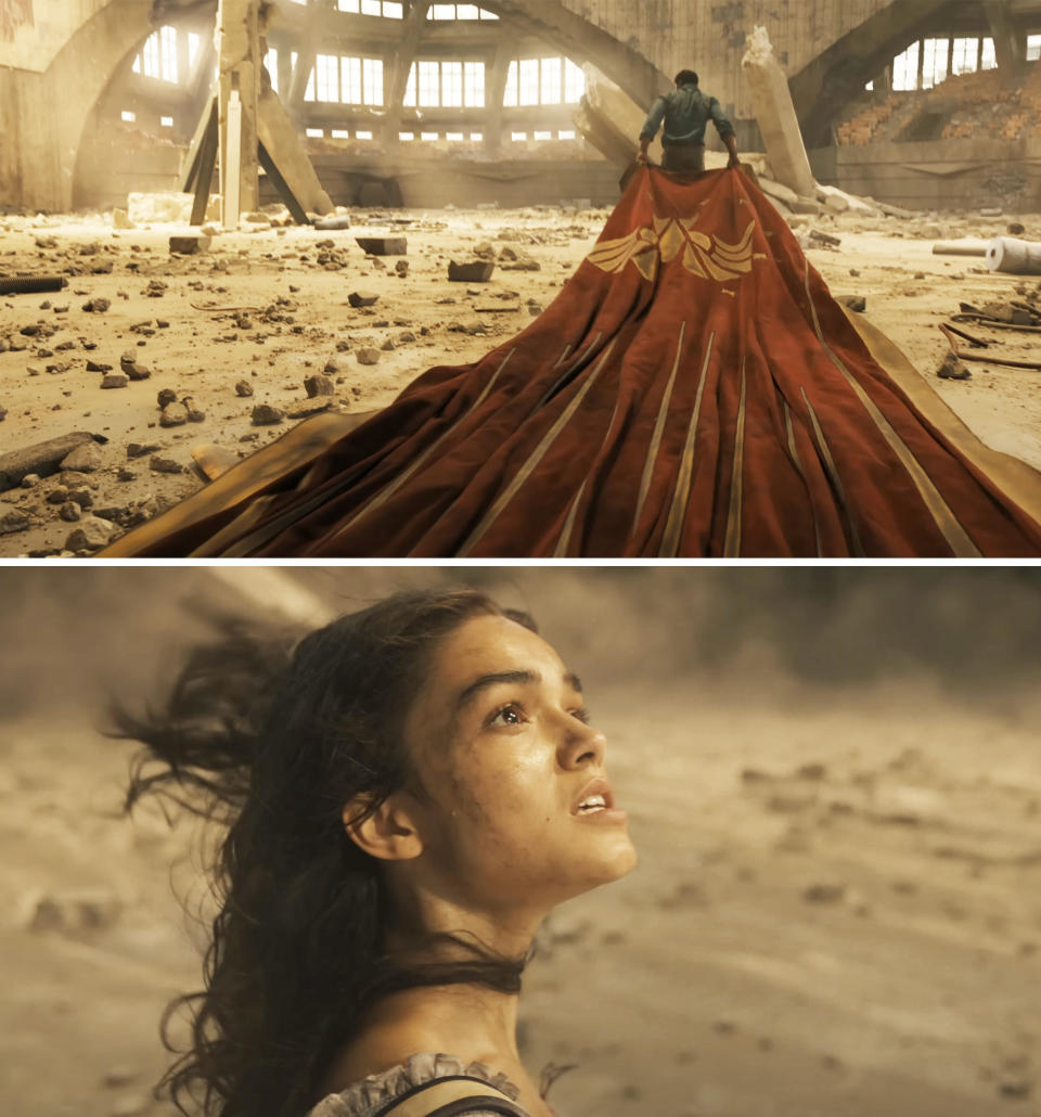 closeup of lucy walking into a building of rubble