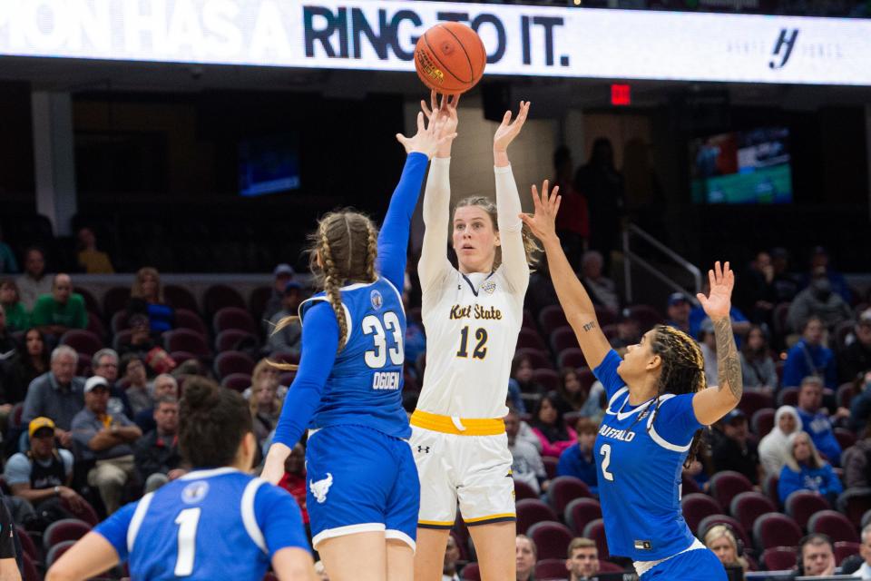 Kent State's Jenna Batsch (12) shoots over Buffalo's Hattie Ogden (33) and Kristen Lewis-Williams (2) during the second half of an NCAA college basketball game in the championship of the Mid-American Conference tournament in Cleveland, Saturday, March 16, 2024. (AP Photo/Phil Long)