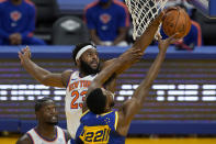 New York Knicks center Mitchell Robinson (23) defends against a shot by Golden State Warriors forward Andrew Wiggins (22) during the second half of an NBA basketball game in San Francisco, Thursday, Jan. 21, 2021. (AP Photo/Jeff Chiu)