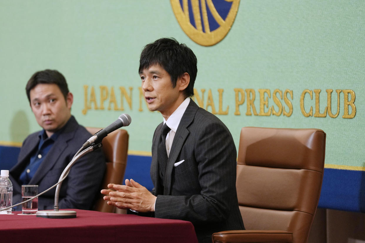 Actor Hidetoshi Nishijima, right, with film director Ryusuke Hamaguchi, speaks during a news conference on their award winning film "Drive My Car" in Tokyo, Tuesday, April 5, 2022. Japan's "Drive My Car" has won an Oscar for best international feature. (AP Photo/Hiro Komae)