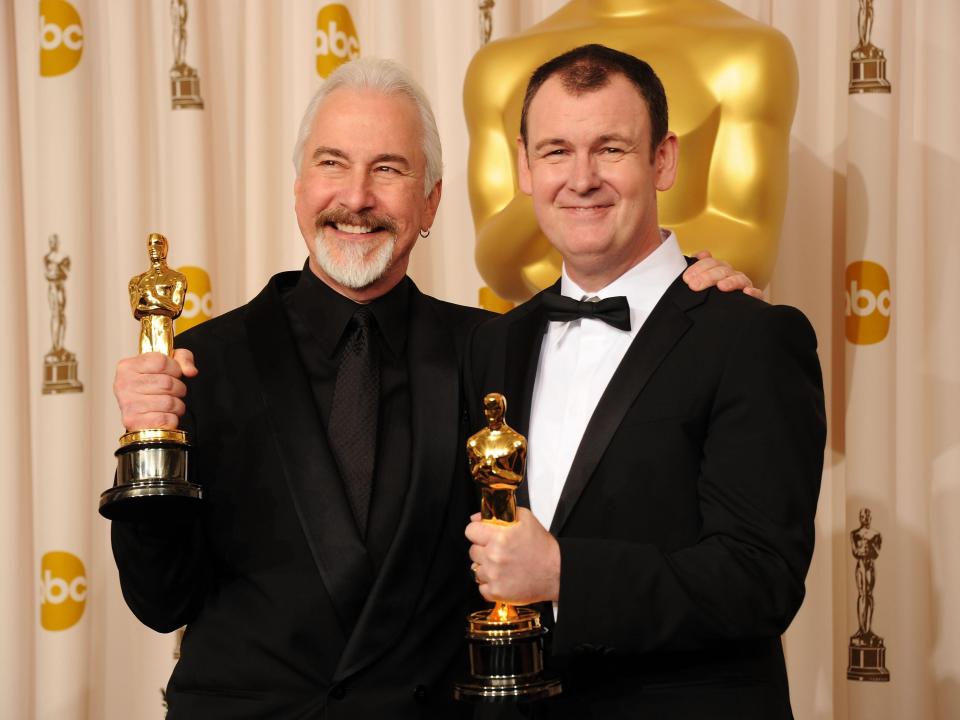 Rick Baker (L) and Dave Elsey (R) pose with their Academy Awards in 2011.