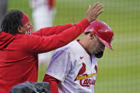 St. Louis Cardinals' Paul Goldschmidt, right, is congratulated by teammate Carlos Martinez after hitting a solo home run during the first inning of a baseball game against the Washington Nationals Tuesday, April 13, 2021, in St. Louis. (AP Photo/Jeff Roberson)