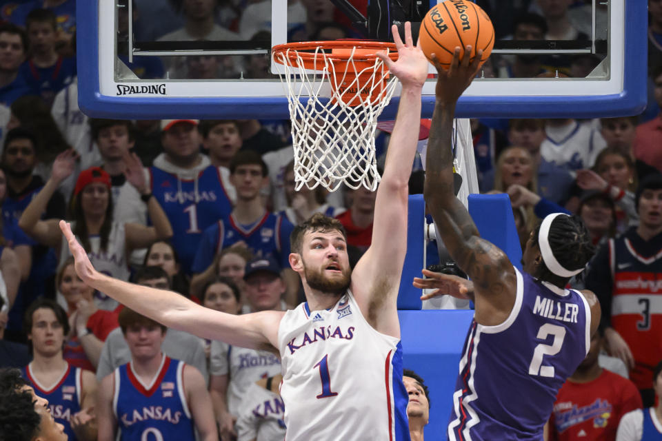 Kansas center Hunter Dickinson (1) tries to block a shot by TCU forward Emanuel Miller (2) during the first half of an NCAA college basketball game in Lawrence, Kan., Saturday, Jan. 6, 2024. (AP Photo/Reed Hoffmann)