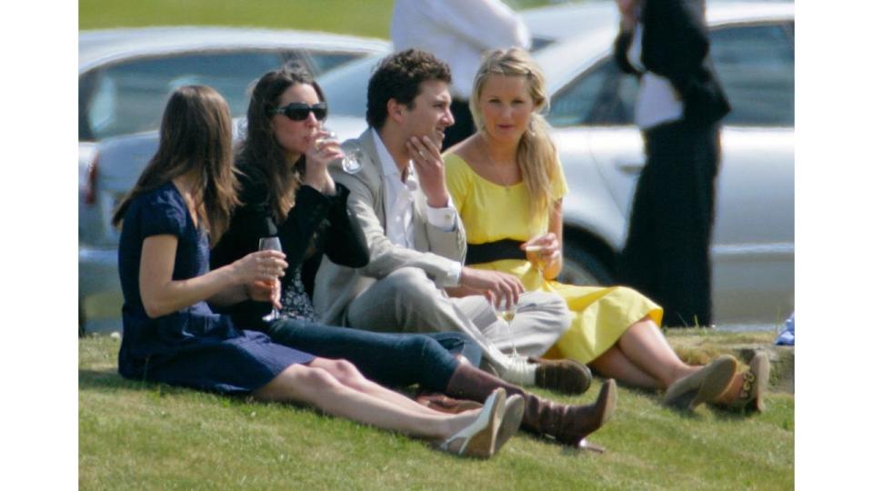 Pippa Middleton and Princess Kate sitting on the floor drinking 