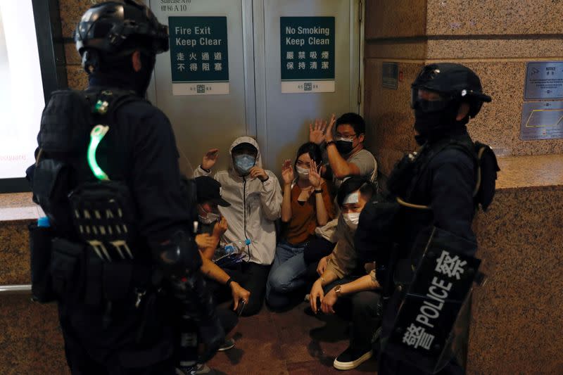 People detained by riot police during a march against national security law at the anniversary of Hong Kong's handover to China from Britain in Hong Kong