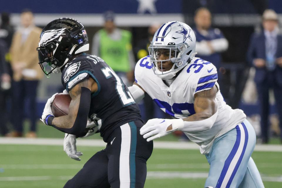 Dallas Cowboys' Damone Clark stops Philadelphia Eagles' Miles Sanders during the first half of an NFL football game Saturday, Dec. 24, 2022, in Arlington, Texas. (AP Photo/Michael Ainsworth)