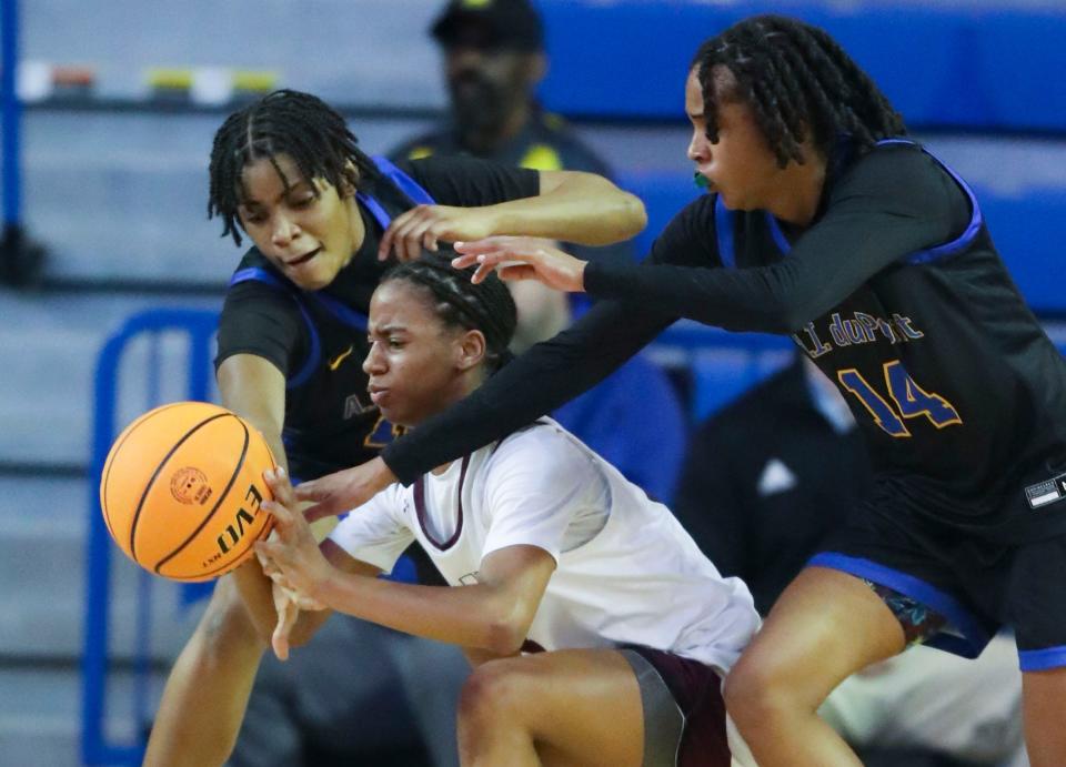 A.I. du Pont's Laila Selby-Blaylock (left) and Sydney Hilliard move for the ball against Caravel's Cherish Bryant in the first half a DIAA state tournament semifinal at the Bob Carpenter Center, Wednesday, March 6, 2024.