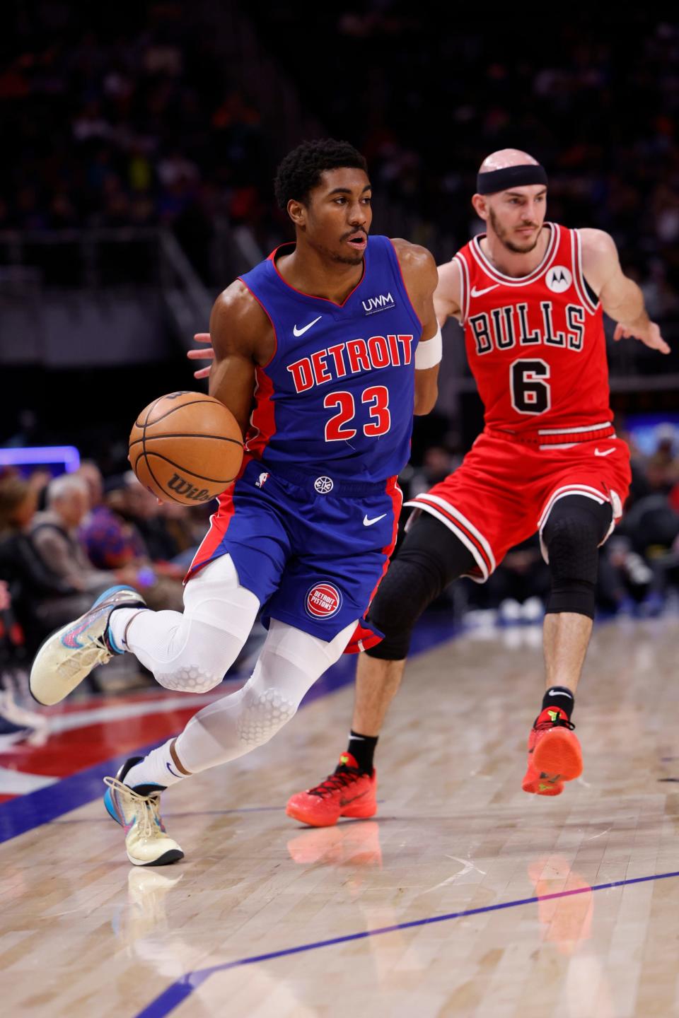 Pistons guard Jaden Ivey dribbles on Bulls guard Alex Caruso in the first half on Thursday, April 11, 2024, at Little Caesars Arena.