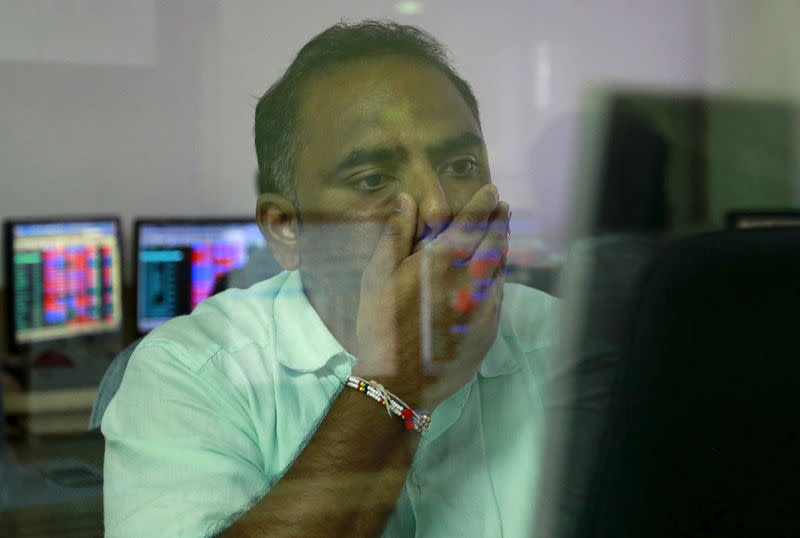 A broker reacts while trading at his computer terminal at a stock brokerage firm in Mumbai, August 24, 2015. REUTERS/Danish Siddiqui/Files