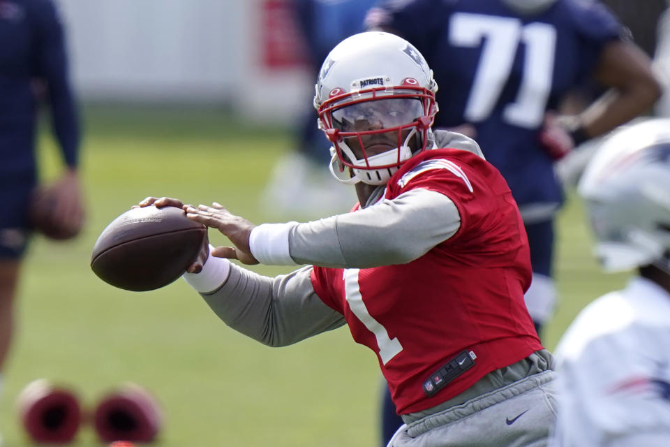 Cam Newton winds up for a pass during practice. 