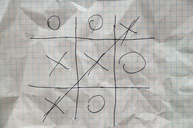 <p>Getty</p> A game of tic-tac-toe on a piece of paper.