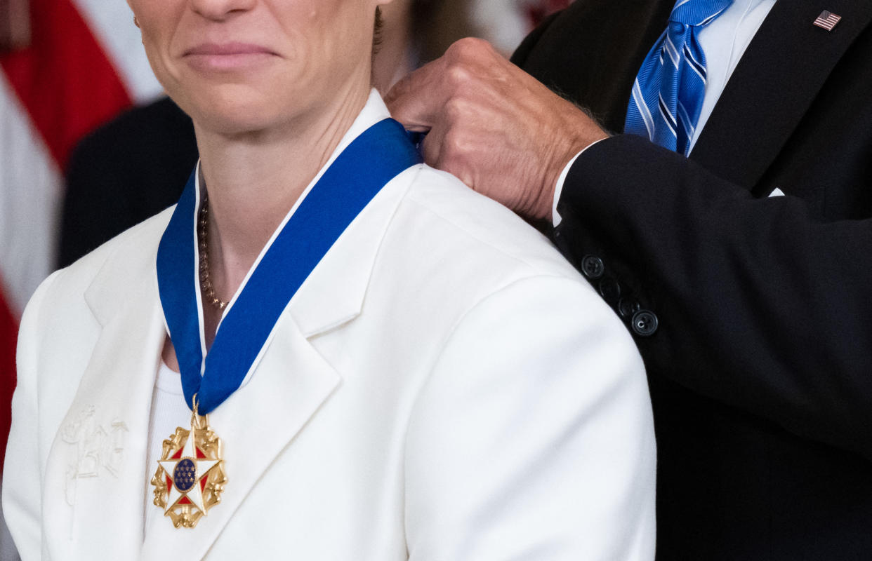 The Suit of US soccer player Megan Rapinoe is embroidered with the initials 'BG', for WNBA player Brittney Griner, who is held in Russia, as US President Joe Biden presents her with the Presidential Medal of Freedom on July 7, 2022. (Photo by SAUL LOEB / AFP) (Photo by SAUL LOEB/AFP via Getty Images)
