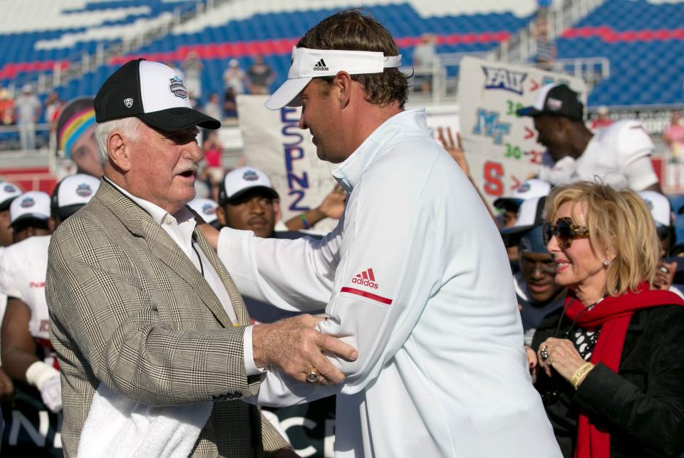 Former Owls head coach Howard Schnellenberger, left, congratulates Florida Atlantic Owls head coach Lane Kiffin at the 2017 Conference USA Football Championship at FAU Stadium in Boca Raton, Florida on December 2, 2017.