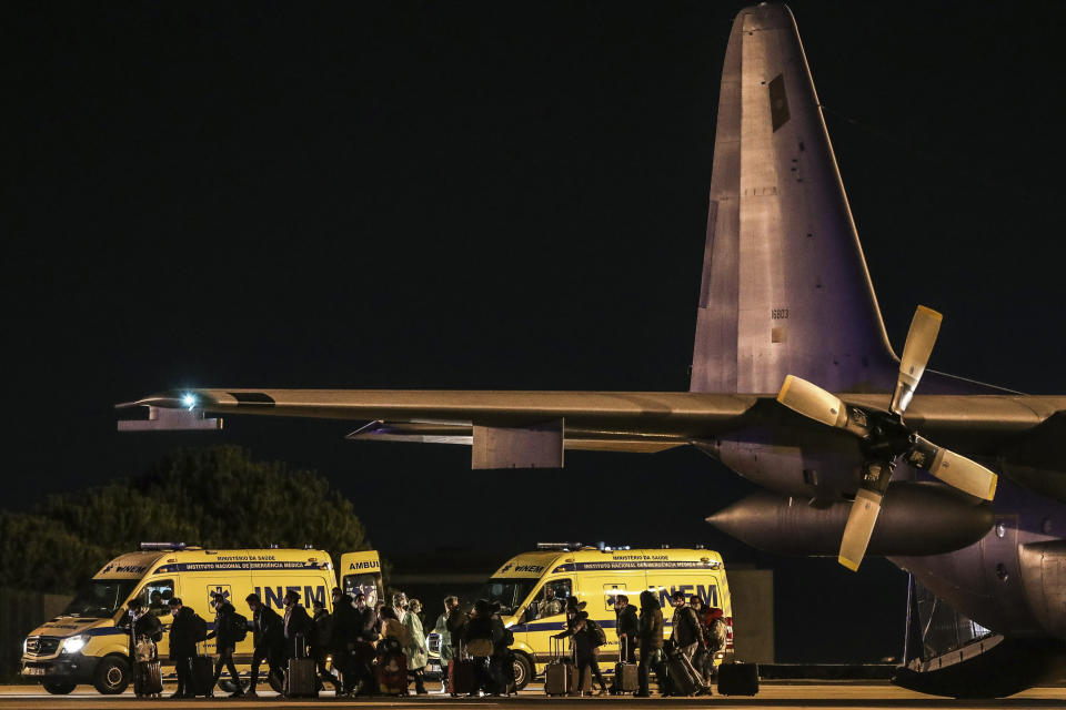 Seventeen Portuguese and two Brazilian citizens returning from the virus-hit city of Wuhan disembark from a Portuguese Air Force C-130 airplane at a military airport in Lisbon. Source: AP