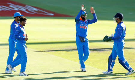 Cricket - India v South Africa - Third One Day International - Newlands Stadium, Cape Town, South Africa - February 7, 2018. India's Virat Kohli celebrates with wicketkeeper MS Dhoni after the dismissal of South Africa's Aiden Markram. REUTERS/Mike Hutchings