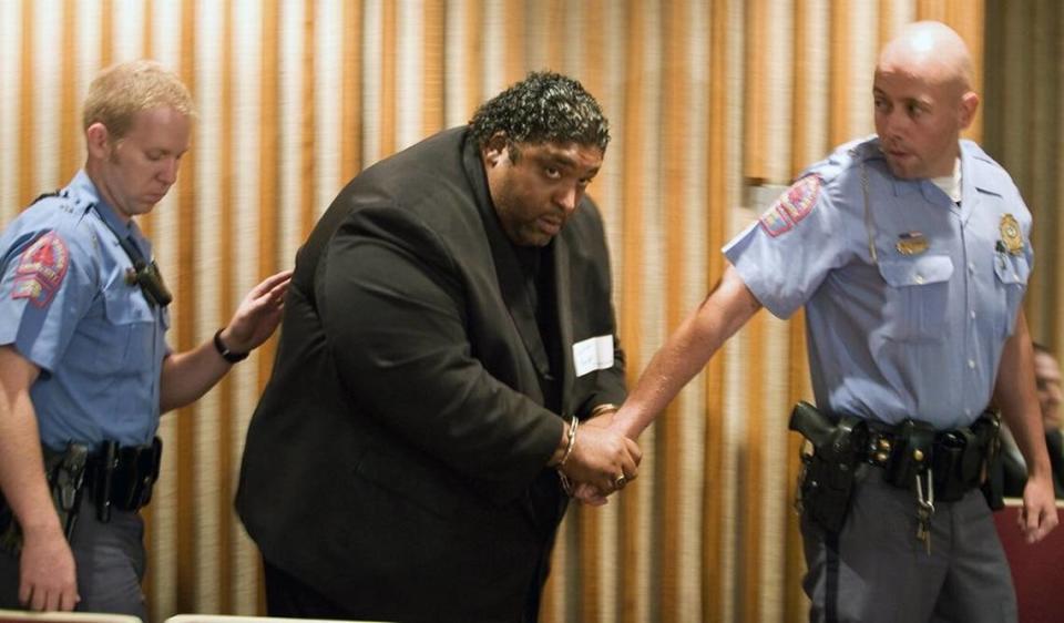 The Rev. William Barber, N.C. chapter president for the NAACP, is escorted from the Wake County Schools board room in handcuffs after he was arrested for staging a sit-in with three other activists during a recess of the board’s meeting on June 13, 2010.