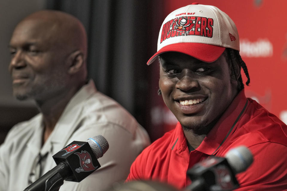 Tampa Bay Buccaneers first-round draft pick Calijah Kancey, right, smiles as he sits with head coach Todd Bowles during an NFL football news conference Friday, April 28, 2023, in Tampa, Fla. Kancey played college football at Pittsburgh. (AP Photo/Chris O'Meara)