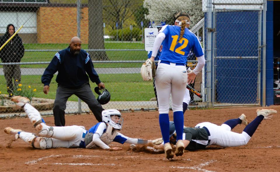 Airport's Natalie Mumbower is tagged out on a slide home by Jefferson catcher Emmi Liptow on Friday, April 21, 2023. Airport won 10-0.