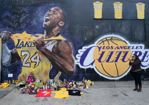 French national and longtime US resident Natalie Burle blows a kiss in direction of Kobe Bryant mural in downtown Los Angeles