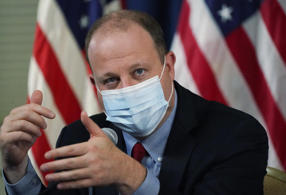 Colorado Governor Jared Polis makes a point during a news conference about the state's spike in cases of the new coronavirus Tuesday, Oct. 13, 2020, in Denver. (AP Photo/David Zalubowski)