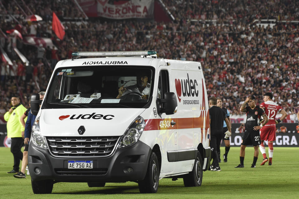 An ambulance leaves the field carrying Javier Altamirano, of Estudiantes de La Plata, during an Argentine soccer league match against Boca Juniors in La Plata, Argentina, Sunday, March 17, 2024. (AP Photo/Ignacio Amiconi)