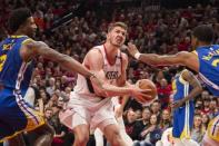 May 20, 2019; Portland, OR, USA; Portland Trail Blazers forward Meyers Leonard (11) drives to the basket against Golden State Warriors forward Jordan Bell (2) and forward Alfonzo McKinnie (28) during the first half in game four of the Western conference finals of the 2019 NBA Playoffs at Moda Center. Mandatory Credit: Troy Wayrynen-USA TODAY Sports