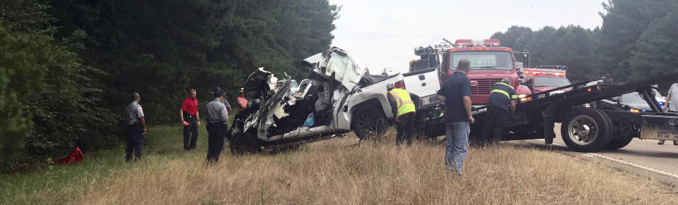 In this photo provided by The Macon Beacon, authorities remove one of several vehicles involved in a fatal crash Wednesday, June 5, 2019, near Scooba, Miss., in the same area where a crash took the lives of eight people two days earlier. Kemper County Sheriff James Moore told The Associated Press that "there will be fatalities" from the wreck on U.S. Highway 45 south of Scooba. (Jeanette Unruh/The Macon Beacon via AP)