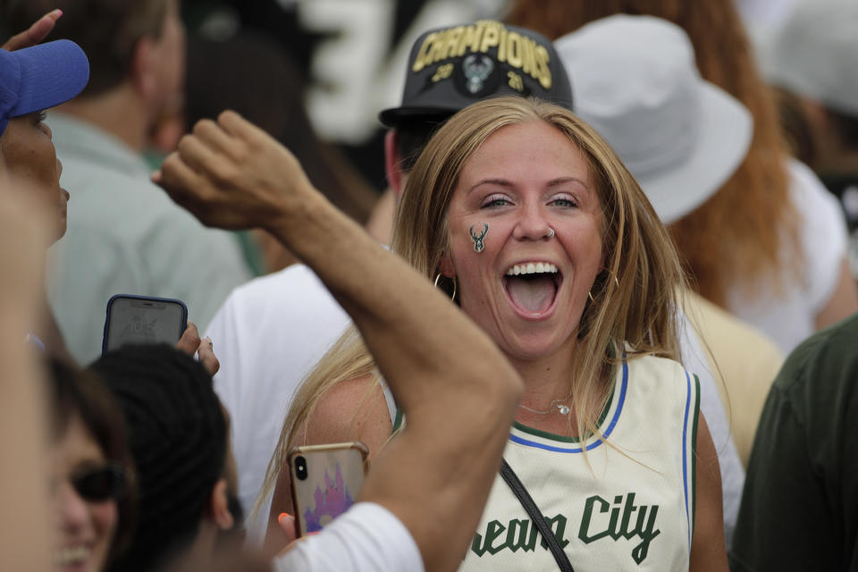 A fan cheers during a parade celebrating the Milwaukee Bucks' NBA Championship Thursday, July 22, 2021, in Milwaukee. (AP Photo/Aaron Gash)
