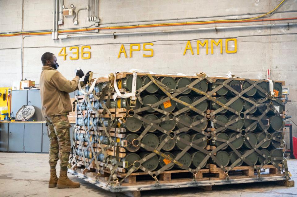 A US airman with the 436th Aerial Port Squadron palletizes ammunition, weapons and other equipment bound for Ukraine in January 2022.