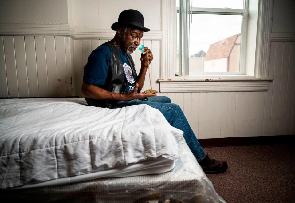 Former boxer and 1972 Olympic gold medalist Sugar Ray Seales holds his gold medal as he sits on a bed in the Shiloh Baptist Church where he is currently living in Tacoma, Wash. on March 29, 2023. Seales fell into homelessness after moving back to his home city of Tacoma after his wife passed away in February 2022.