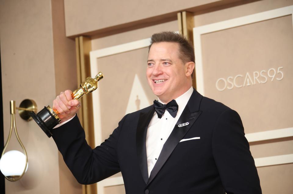 Brendan Fraser, who won the best actor Oscar for "The Whale," enjoys his new trophy backstage at the 95th Academy Awards.