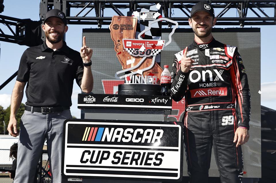 SONOMA, CALIFORNIA - JUNE 12: Daniel Suarez, driver of the #99 Onx Homes/Renu Chevrolet, (R) celebrates with Ross Chastain, driver of the #1 Worldwide Express Chevrolet, in victory lane after winning the NASCAR Cup Series Toyota/Save Mart 350 at Sonoma Raceway on June 12, 2022 in Sonoma, California. (Photo by Chris Graythen/Getty Images) | Getty Images