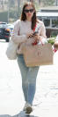 <p>Primed for a shopping spree, Garner took to the streets of Los Angeles in a pale pink knit sweater (shop a similar item <a rel="nofollow noopener" href="http://www.pjtra.com/t/8-9711-131940-104709?sid=ISJenniferGarnerpinksweaterIJ&url=https%3A%2F%2Fwww.everlane.com%2Fproducts%2Fwomens-chunky-knit-cotton-crew-palepink%3Futm_source%3D" target="_blank" data-ylk="slk:here;elm:context_link;itc:0;sec:content-canvas" class="link ">here</a>), light-wash jeans, and a casual set of sneaks, a gold chain and narrow pendant hanging from her neck. </p>