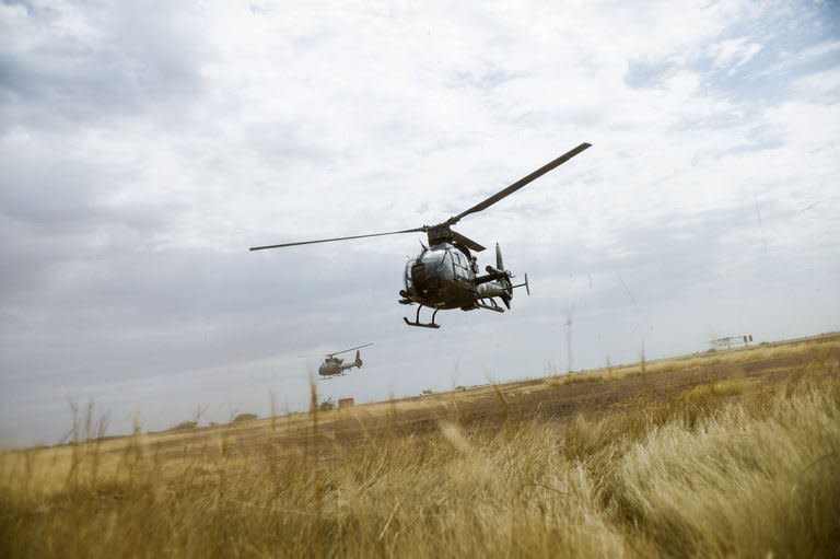 French Gazelle military helicopters, flying back from the city of Timbuktu, arrive at the French army base camp airport on January 28, 2013, in Sevare. The advance into Timbuktu, known as "the City of 333 Saints", comes a day after French and Malian soldiers seized another Islamist bastion, the eastern town of Gao