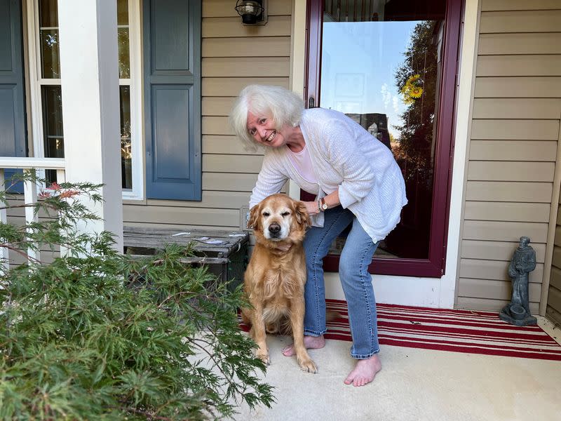 Mary Jane Mitchell-Musumarra poses for a photo with her dog Fenway at her home in Stafford