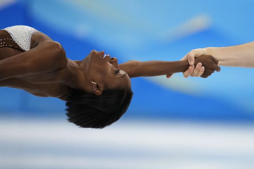 Vanessa James and Eric Radford, of Canada, compete in the pairs short program during the figure skating competition at the 2022 Winter Olympics, Friday, Feb. 18, 2022, in Beijing. (AP Photo/Natacha Pisarenko)