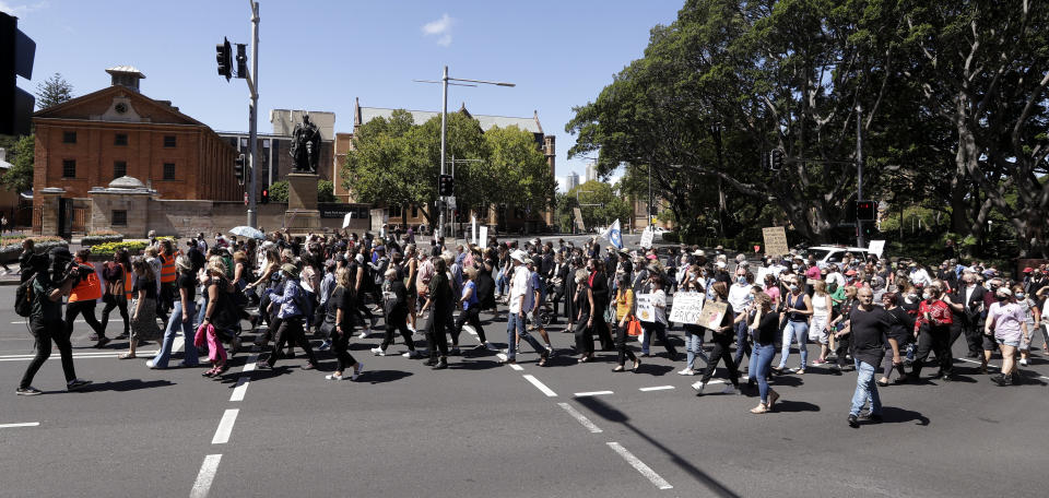 Thousands of people with placards and banners rally demanding justice for women in Sydney, Monday, March 15, 2021, as the government reels from two separate allegations. The rally was one of several across Australia including in Canberra, Melbourne, Brisbane and Hobart calling out sexism, misogyny and dangerous workplace cultures. (AP Photo/Rick Rycroft)