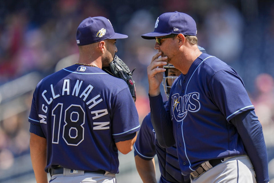 Tampa Bay Rays starting pitcher Shane McClanahan and pitching coach Kyle Snyder talk during the fourth inning of a baseball game against the Washington Nationals at Nationals Park, Wednesday, April 5, 2023, in Washington. (AP Photo/Alex Brandon)