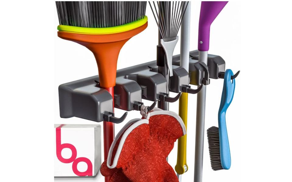 Get those <a href="https://amzn.to/3lGsSfS" target="_blank" rel="noopener noreferrer">brooms, mops, rakes and other cleaning tools</a> off your floors, out of the closets and neatly organized once and for all with this organizer. It includes six hooks and five slots for storing handles. You won't believe how you've gone this long without it. <a href="https://amzn.to/3lGsSfS" target="_blank" rel="noopener noreferrer">Get it on Amazon</a>.